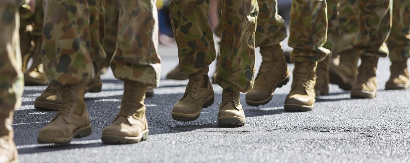 a line of people's feet up to the knees in military uniform
